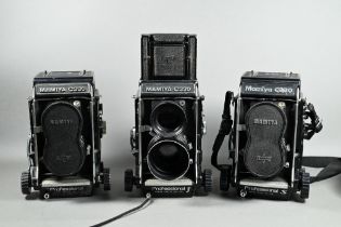 Three Mamiya C330 twin-lens reflex cameras with accessories