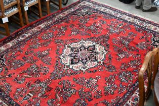 An Indo-Persian Sarouk carpet, the traditional floral design on red ground with ivory palmette