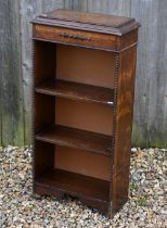 A 1920's oak dwarf three-tier bookcase, 46 cm x 22 cm x 92 cm h