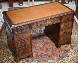 A reproduction Victorian style mahogany twin pedestal desk, with gilt tooled green leather top