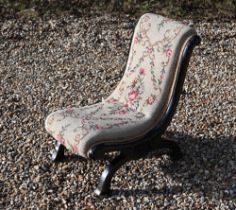 A Victorian ebonised needlepoint slipper chair