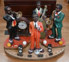 A novelty plastic jazz group incorporating clock, 41 cm high x 57 cm wide