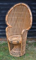 A classic high fan back wicker chair circa 1970's