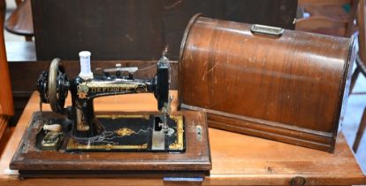A vintage 'Defiance' brand hand crank sewing machine, in original wooden dome case