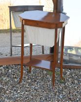 An antique satinwood work table, the octagonal hinged top enclosing a part fitted interior and