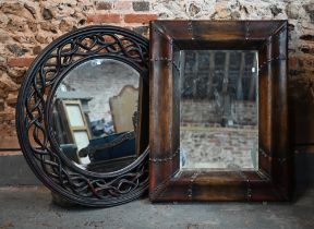 A bevelled rectangular mirror in moulded simulated leather frame, 110 x 88 cm to/w bevelled circular