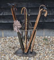 A Victorian-style cast iron stick stand, to/w three silver-mounted sticks and various others