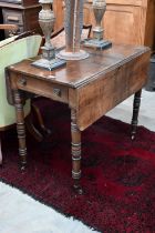 A 19th century mahogany drop-leaf table with end drawer and turned supports