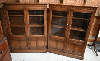 A pair of Ercol part-glazed elm bookcases, each 101 cm w x 31 cm x 138 cm h (2)