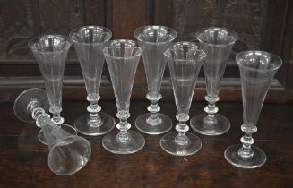 A set of eight Georgian style ale glasses with conical bowls, on blade knop stems, the bases with