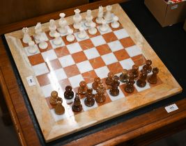 An onyx and marble chessboard with chessmen