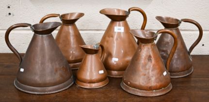 Six antique conical copper rum-measures (6)