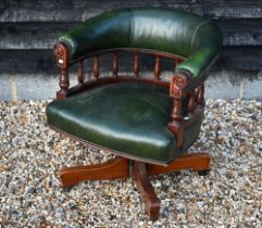 A mahogany framed green leatherette desk chair