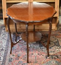 An Edwardian two-tier occasional table, raised on six shaped legs, 74 cm dia. x 70 cm h