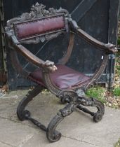 A Victorian carved and moulded studded leather seat Bishops chair with dragon head arm terminals, on