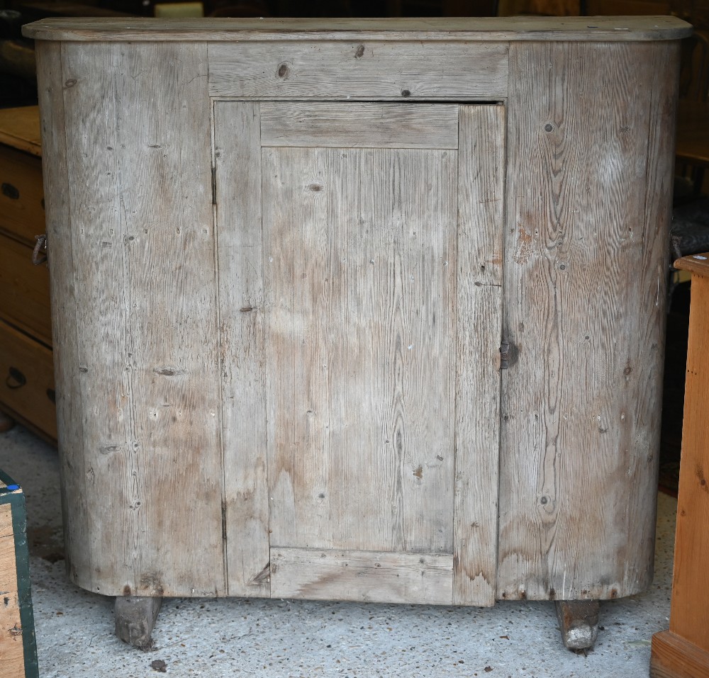 An antique French stripped pine cupboard, with rounded ends centred by a single door, raised on - Image 2 of 3