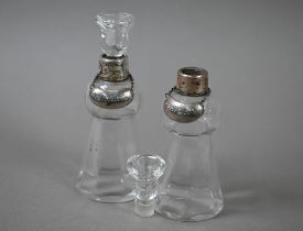 A pair of thistle-shaped glass whisky noggins with silver collars, Schindler & Co, London 1910, c/