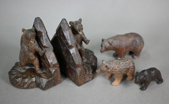 A pair of Black Forest carved bear book-ends, to/w a matched graduated set of three bears