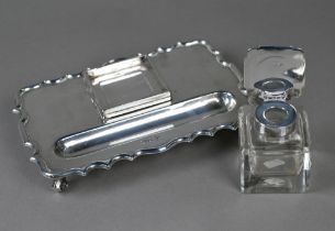 A heavy quality silver inkstand with silver-topped square cut glass inkwell, shaped rim and four