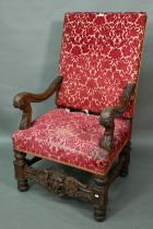 A Victorian carved and moulded oak framed throne chair