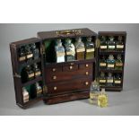 A 19th century mahogany apothecary box, fitted with glass bottles and drawers with ivory knobs,