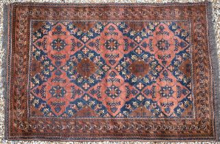 An old brown ground Baluch rug, 188 cm x 128 cm