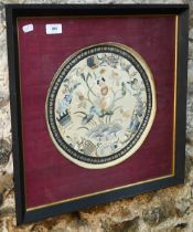 An early 20th century Chinese kesi work silk embroidered circular panel with an infant seated on a