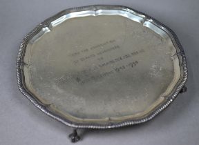 A silver letter salver with gadrooned rim and claw and ball feet, Garrard & Co, Sheffield 1954, 11.