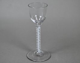 An 18th Century cordial glass with ogee bowl on opaque twist stem, the domed foot with pontil