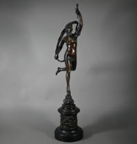 An antique brown bronze sculpture after Giambologna of Fortuna, raised on a relief cast circular