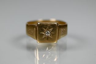 A 9ct yellow gold signet ring with starburst set diamond, size S, approx 4.4g