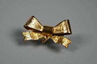 A 9ct yellow gold brooch formed as a ribboned bow with engraved decoration, 3 x 1.5 cm, approx 2.5g,