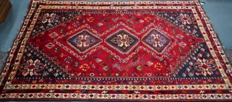 A South West Persian Qashqai carpet, the triple pole design on red ground, 260 cm x 165 cm