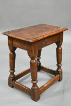 An antique oak joint stool