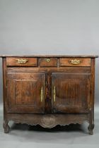 An antique provincial French oak cupboard, Normandy, with three drawers over a pair of mitre