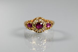 An antique ruby and diamond cluster ring, the central oval ruby surrounded by small eight-cut