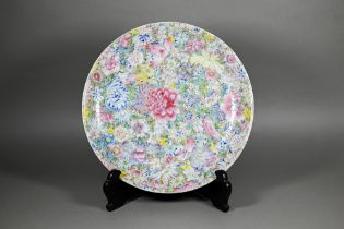 A Chinese famille rose mille-fleur charger painted with floral design in bright polychrome enamels