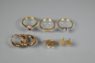 Three gold rings including an 18ct seven stone half eternity ring set diamonds, size T 1/2; a ruby