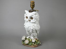 A Victorian china lamp base, modelled as an owl standing on floral-encrusted base, with glass