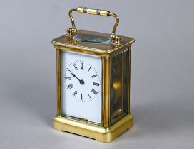 A small French brass single drum 8-day carriage clock, with white enamelled dial with Roman