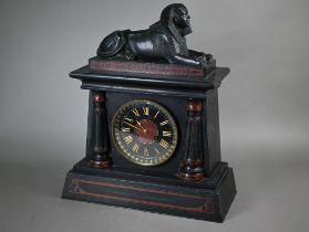 A Victorian Egyptian Revival slate mantel clock, surmounted by a bronzed sphinx, the black dial with