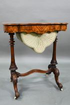 A Victorian inlaid figured walnut work table, with a fitted interior over a plaited silk storage