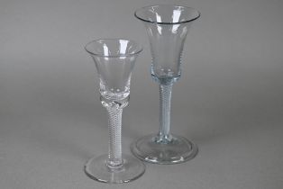 A drinking glass with bell bowl on air twist stem and folded foot, 17 cm to/w a small example on
