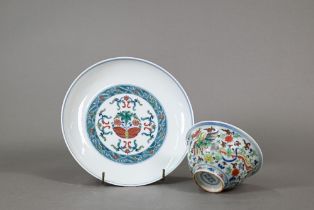 A Chinese doucai dish painted in polychrome enamels with butterflies and scrolling floral designs