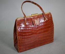 Asprey - A vintage brown crocodile handbag, circa early 1960s, with twin handles, gold tone hardware