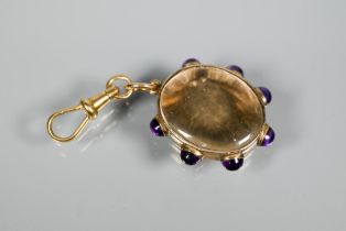 A 9ct yellow gold locket set cabochon amethysts with Albert swivel clasp attached, approx 8.9g all