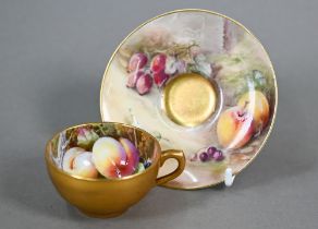 A Royal Worcester miniature gilded cabinet cup and saucer painted with fruit, the 5.8 cm diameter