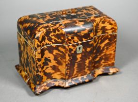 A Victorian serpentine-front tortoiseshell tea caddy with two inner lidded compartments, on ivory