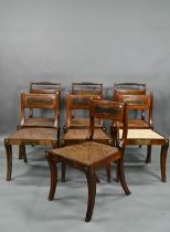 A set of five Regency brass inlaid mahogany caned seat side chairs with sabre front legs to/w four