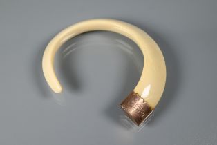 A 9ct gold-mounted boar's tusk bangle, the mount with initials EBR, approx 6.5 cm diam